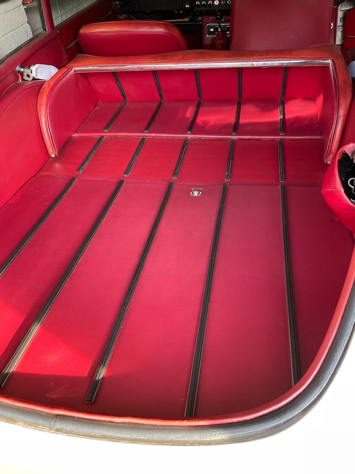 Rear seat folded forward to form the extended luggage platform in a Series 1 Jaguar E-Type 2+2