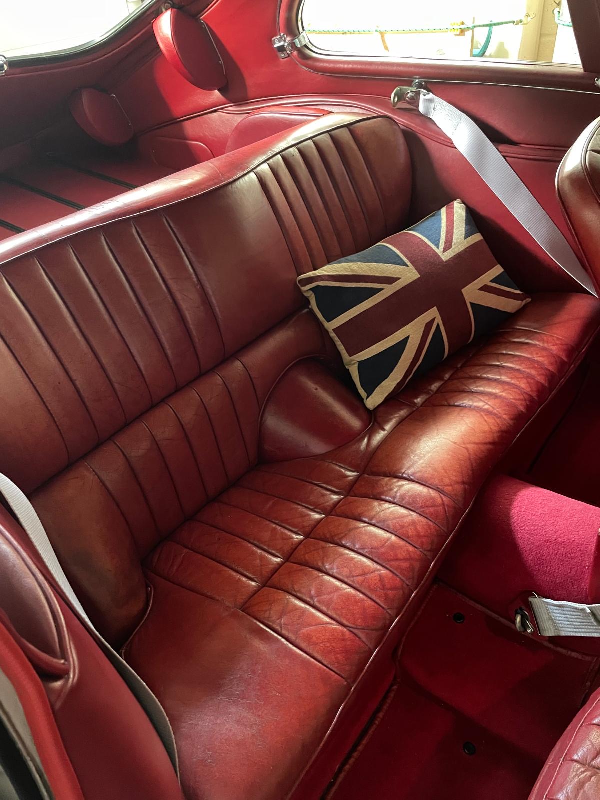 Red leather occasional rear seat in a Series 1 Jaguar E-Type 2+2